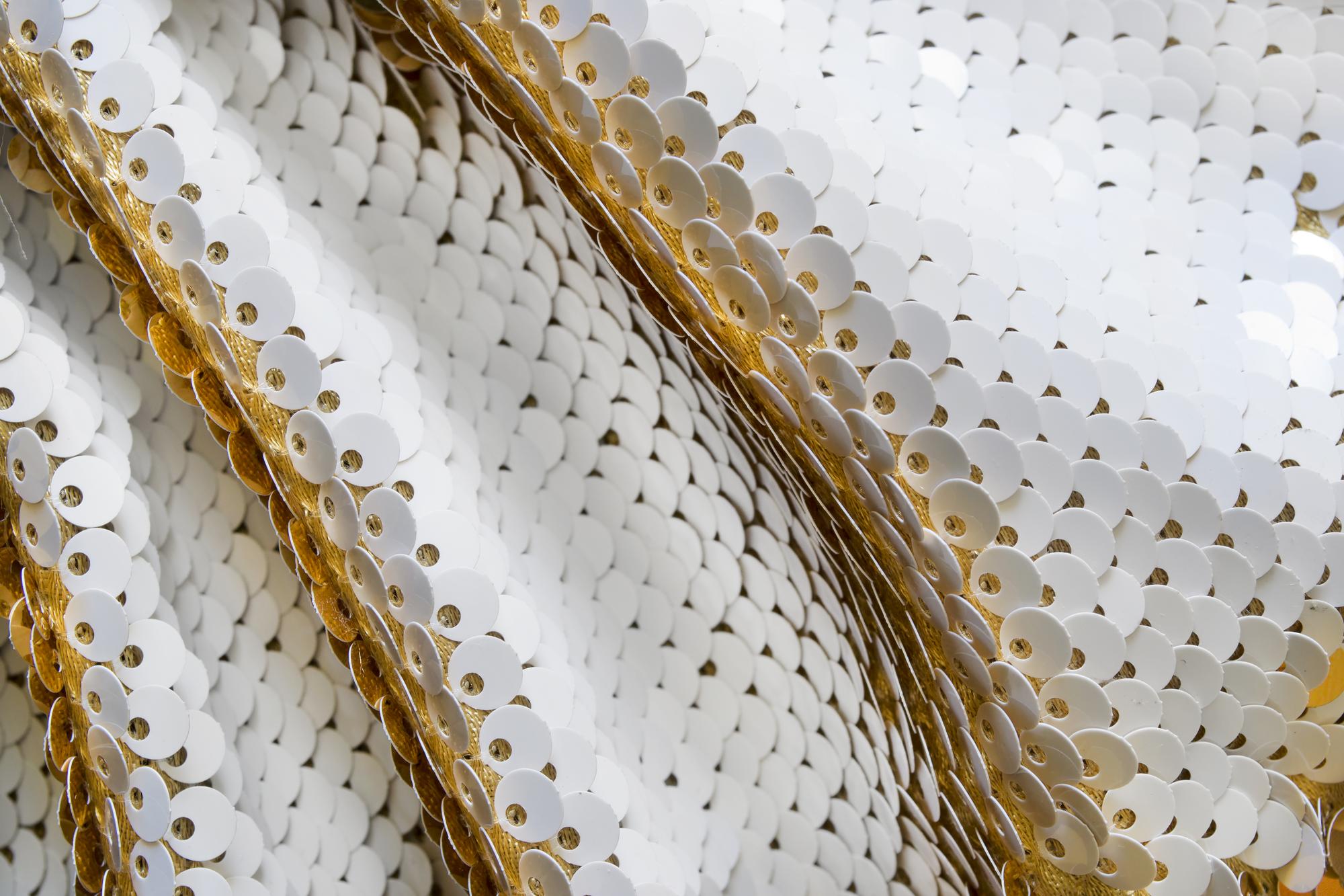 Close-up of gold thread embroidery on silk